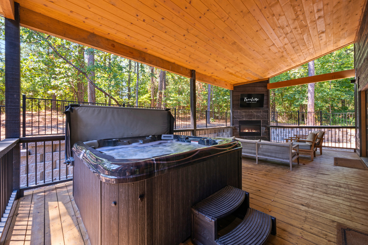 Ease into the hot tub beneath the covered deck, where the surrounding trees and open-air setting make it a relaxing place to unwind and enjoy the peaceful outdoors.