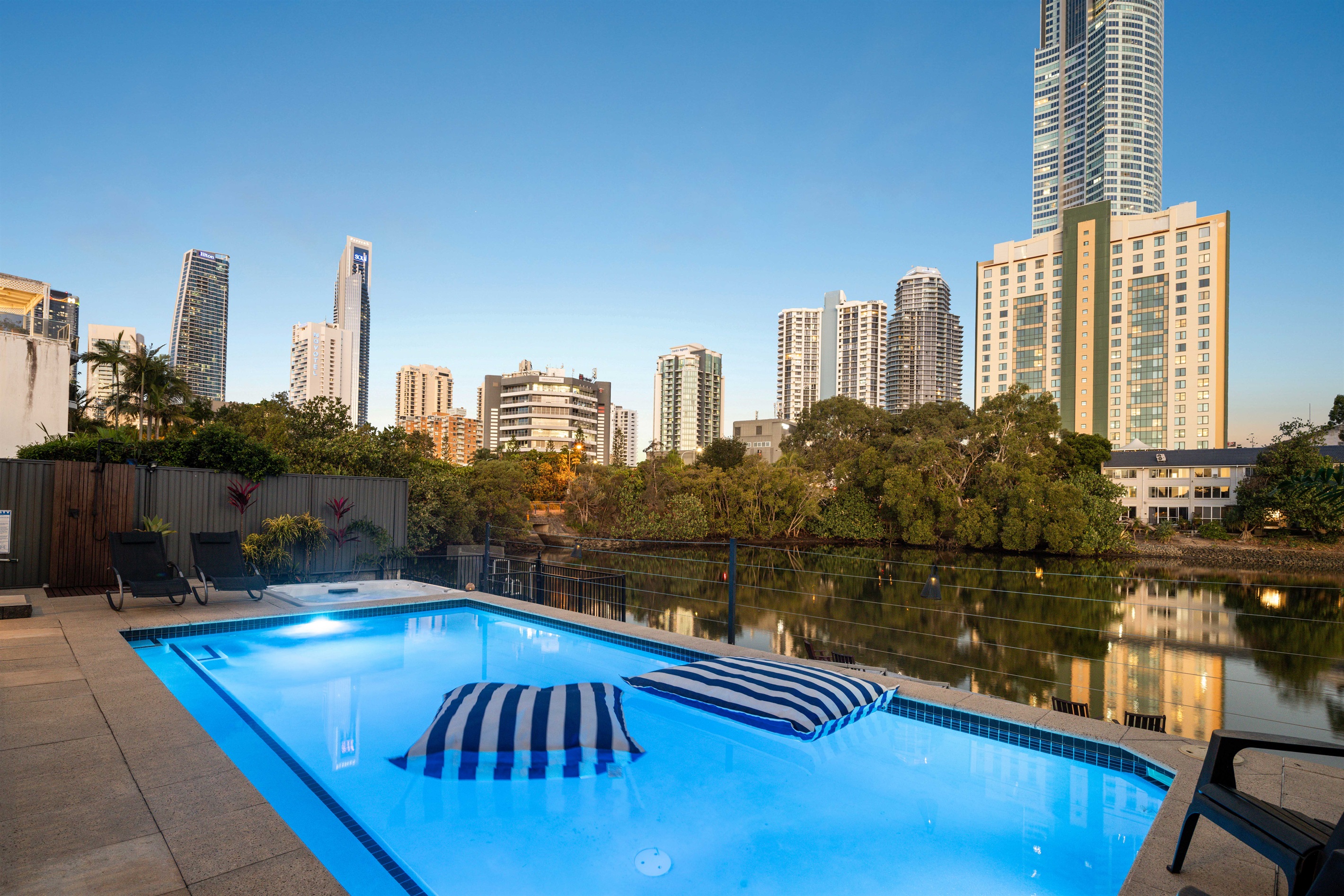 Sunlit poolside setting framed by the iconic Gold Coast skyline.