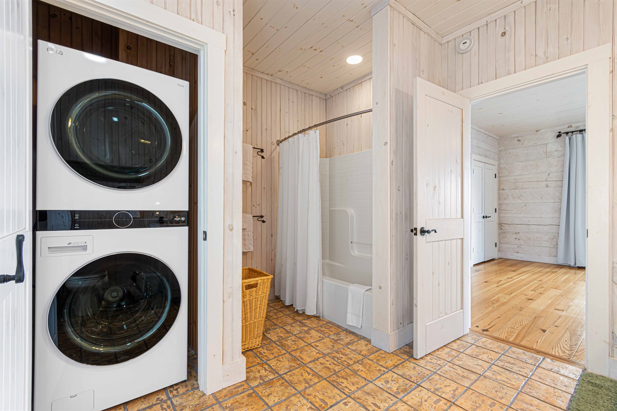 Laundry Area: Convenient washer/dryer combo, stylish decor, and easy access to fresh towels!