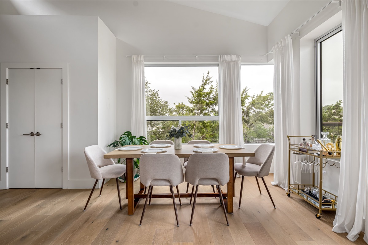 Bright dining area surrounded by windows and scenic views