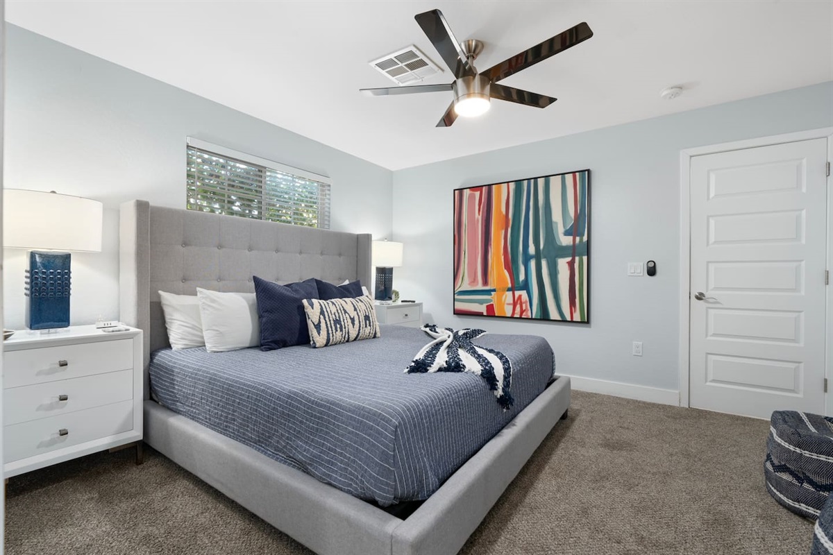 Spacious bedroom with a warm, inviting ambiance, designed for comfort and relaxation.