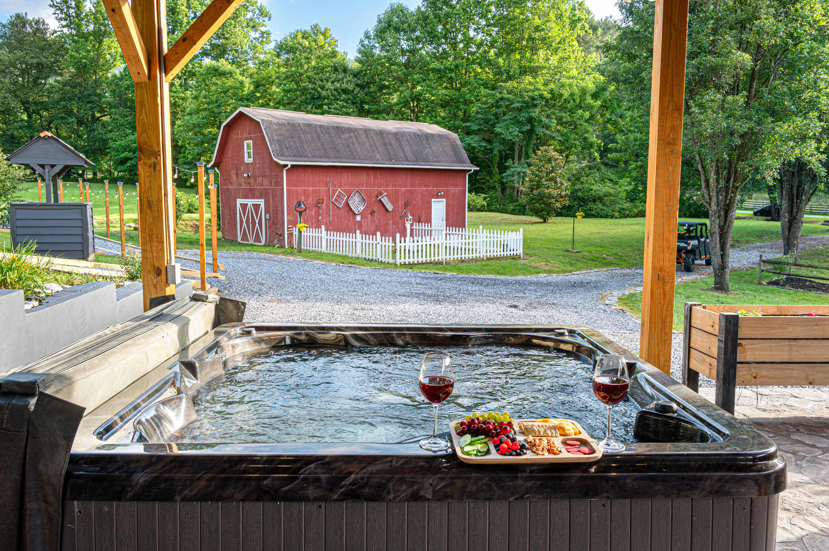 Hot Tub Oasis: Unwind in the bubbling warmth with stunning views of nature and red barn charm!