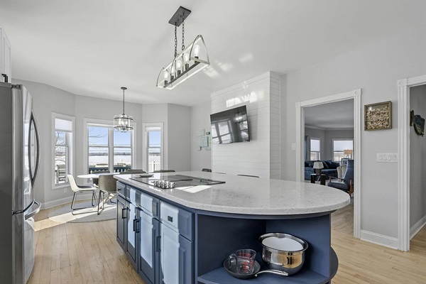 This open, light-filled kitchen combines spacious island seating, a charming breakfast area, ad breathtaking lakefront views from nearly every angle.