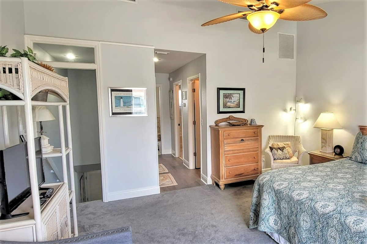 Sleep in the king master suite &mdash; roomy, well-appointed, with its own Smart TV and private deck access through the door.
