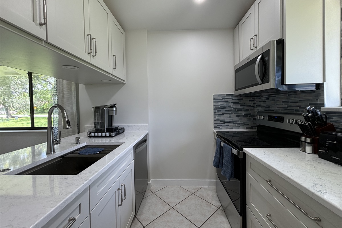 The galley-style kitchen is well-equipped with all the essentials needed to make home-cooked meals together.