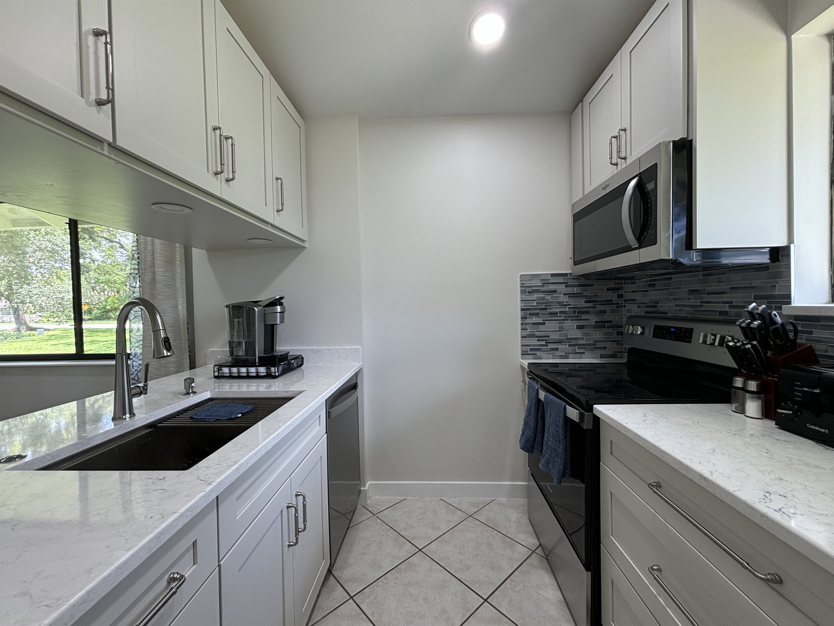 The galley-style kitchen is well-equipped with all the essentials needed to make home-cooked meals together.