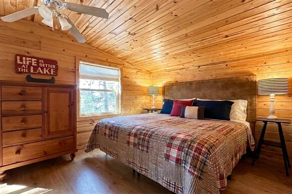 Wake up to tranquil lake views and the call of loons from the king bed in the upstairs primary bedroom - calm, cozy, and surrounded by nature. King Bed - Upper Level, Primary Bedroom 