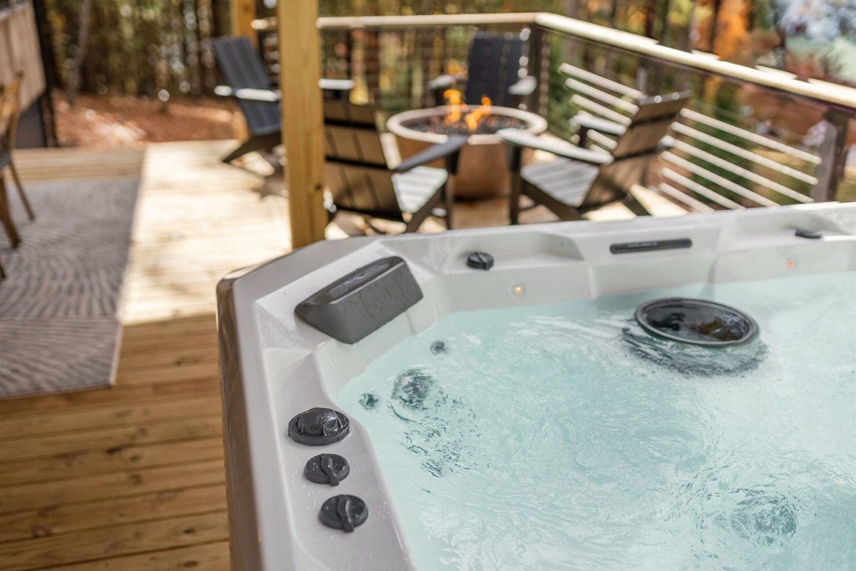 A private hot tub with lake and mountain views provides the perfect space to relax and unwind.