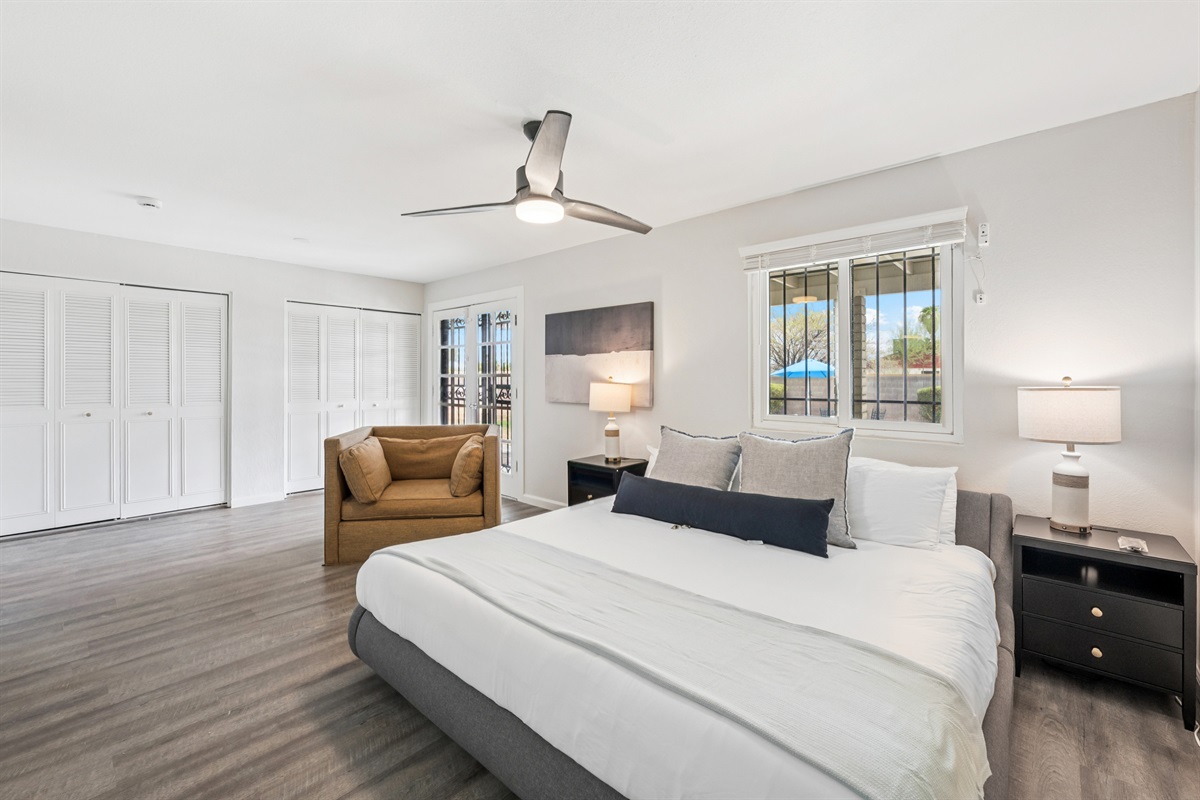 The primary bedroom features a modern king size sleigh bed