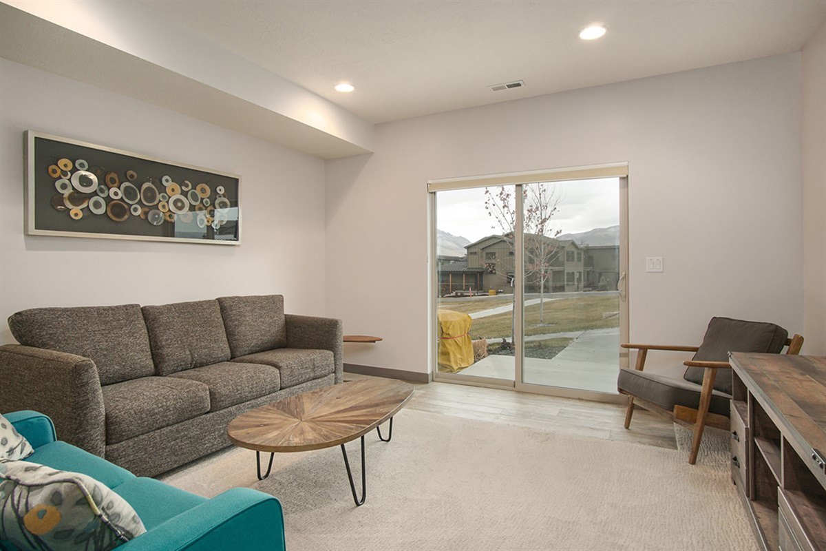 A cozy downstairs family room with walk-out access, providing additional living space and seamless indoor-outdoor flow.