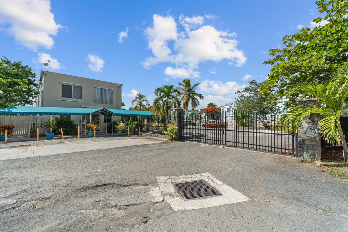 Gated entrance with a walking gate that also requires a code.