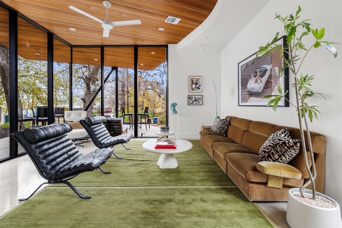 Comfortable seating arranged for conversation, framed by natural light and warm wood ceilings.