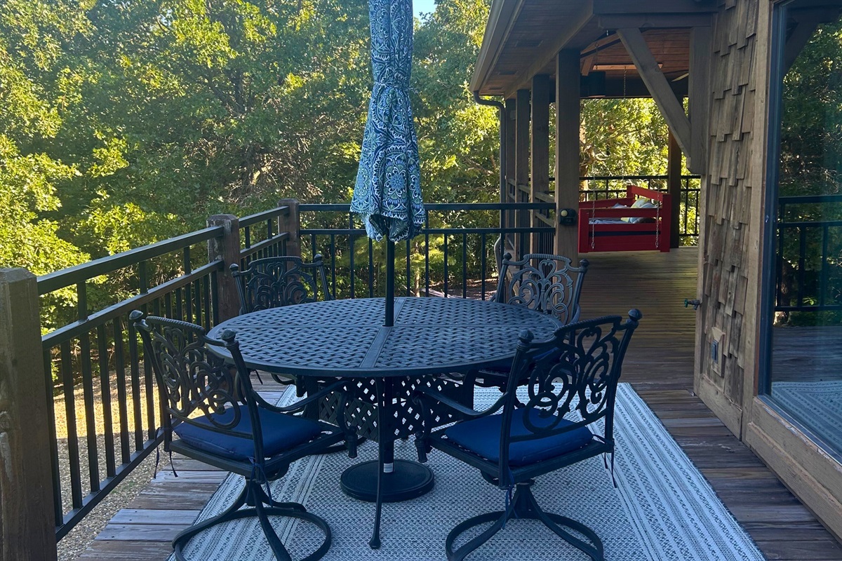Relax or dine outdoors on the back deck with forest views and cozy seating.
