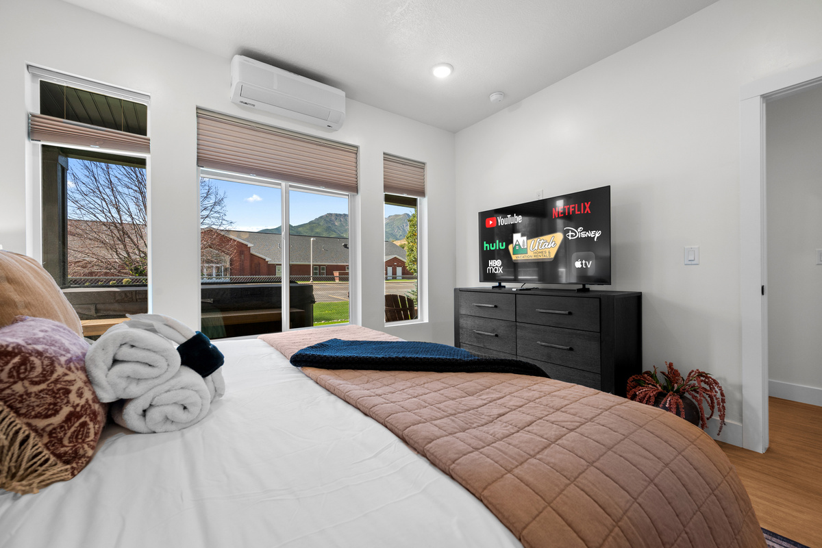 A spacious bedroom with plenty of natural light creates a relaxing private retreat within Powderline Lodge.