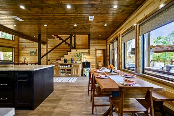 Gather around the spacious dining table where laughter flows as easily as the conversation—perfect for family feasts or cozy cabin breakfasts