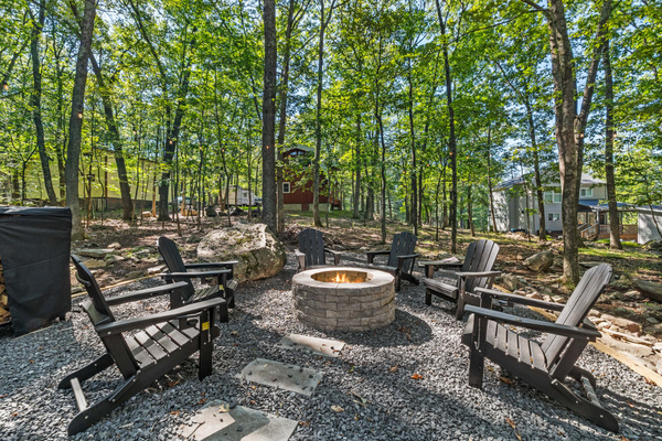 Mature Poconos trees wrap completely around the yard, creating a semi- private, nature-filled sanctuary