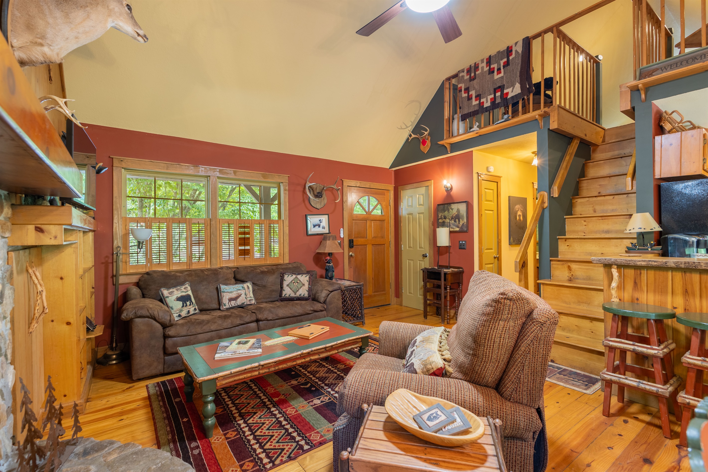 With its vaulted ceilings and inviting atmosphere, the living area blends rustic cabin charm with everyday comfort.