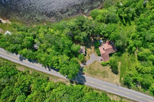 Overhead shot of the lake and cabin. No one lives in the large house next door to the cabin, you will have the entire grounds to yourself.