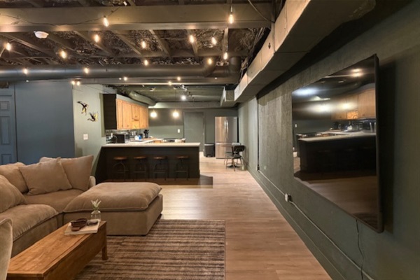 Spacious living area with 85” TV—perfect for relaxing or game day viewing