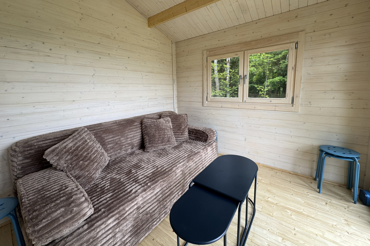 A comfortable sitting area offers a quiet place to relax while enjoying views of the surrounding forest.
