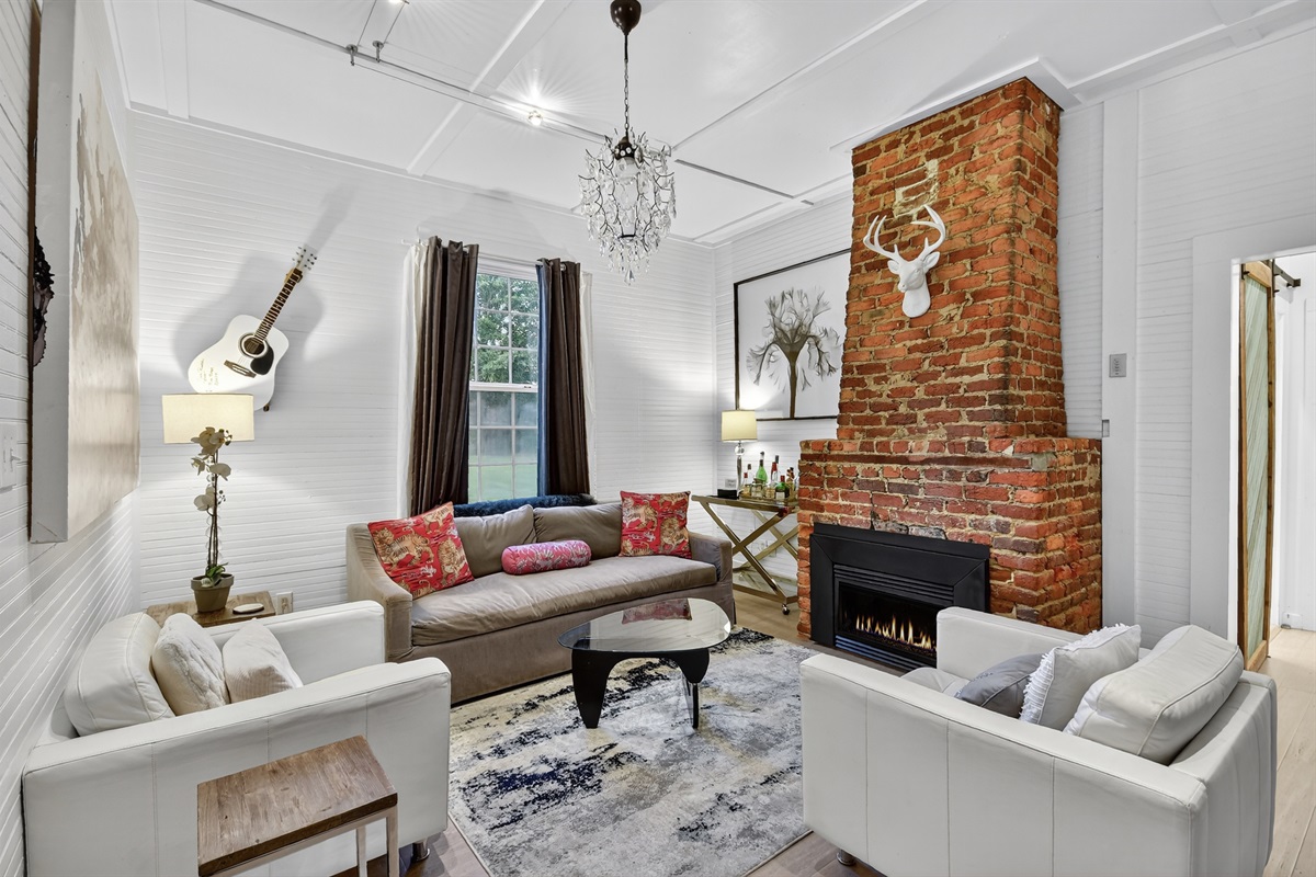Gather around the fireplace in this inviting living room&mdash;complete with comfy seating, curated art, and warm charm just minutes from downtown Blue Ridge.
