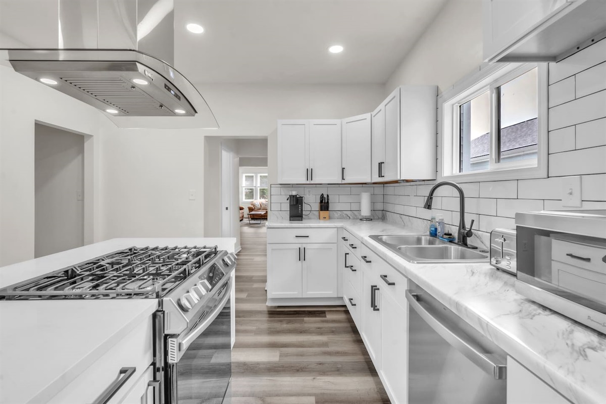 Bright and modern all-white kitchen interior, creating a clean and fresh space for cooking and dining.