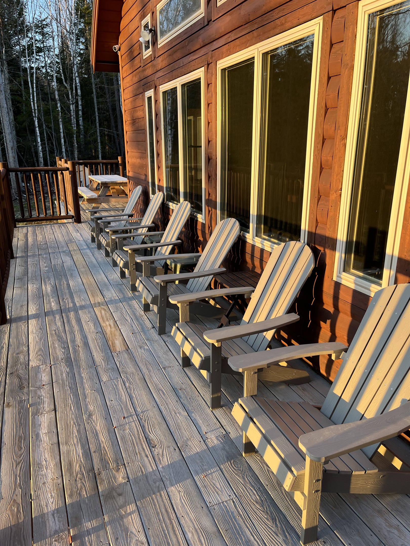 Adirondack chairs on the deck overlooking the lake for some amazing sunsets! Large deck (covered and uncovered). Enjoy the views, the outdoor fireplace, the grill with a seating area. Imagine sitting here with your coffee in the morning listening to loons.