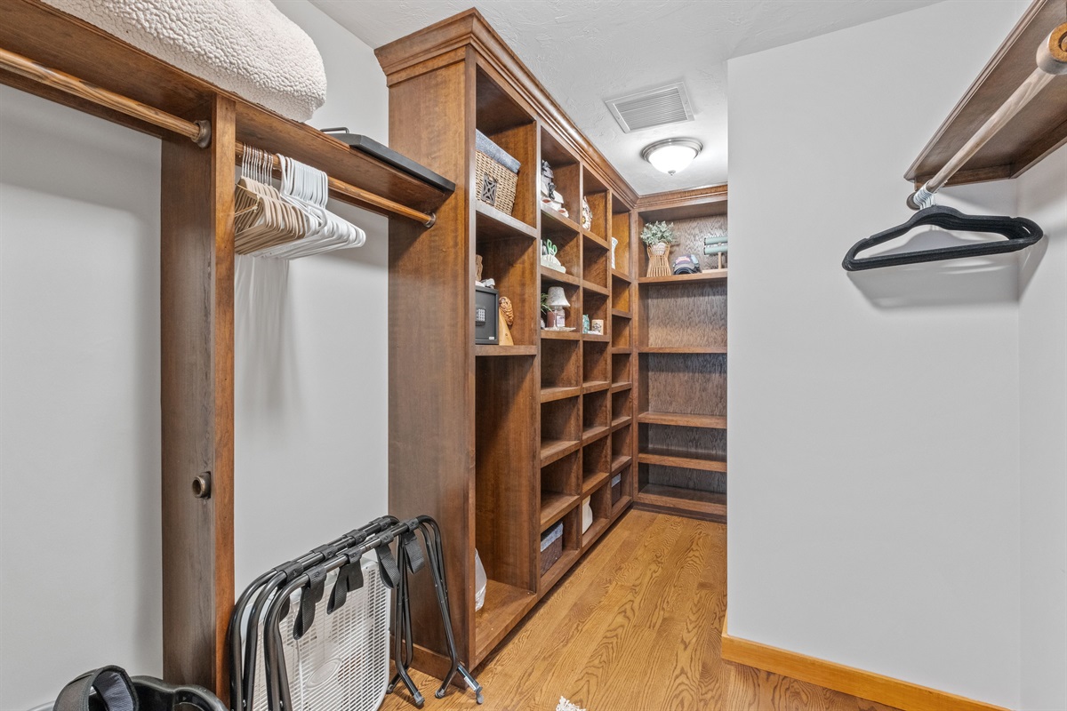 Closet in the second floor master bedroom ensuite with king bed and couch and its own bathroom