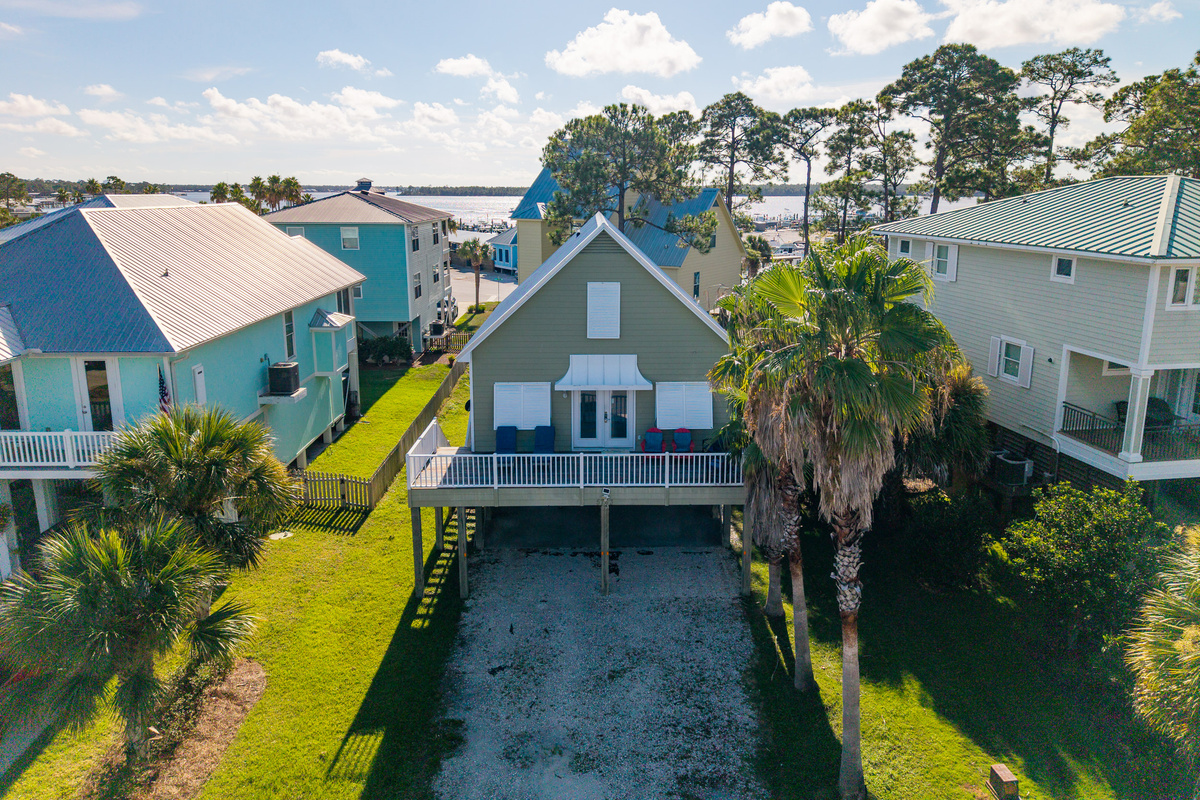 An aerial view shows just how close the home sits to Bear Point's waterways — a favorite spot for boating, fishing, and kayaking.