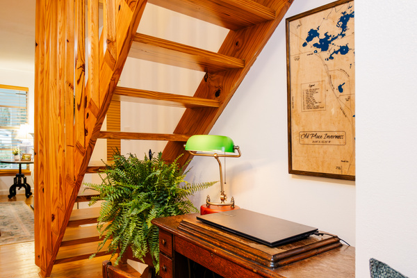The pine stairway to the loft, with a quiet workspace nook tucked below.