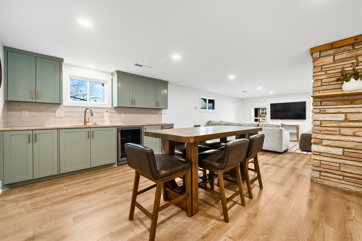 The casual dining space downstairs offers a comfortable spot for quick meals, board games, or late-night conversations.