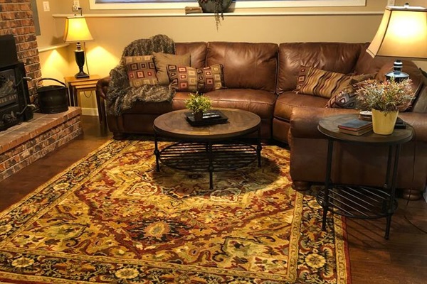 Family Room downstairs with wood-burning fireplace.