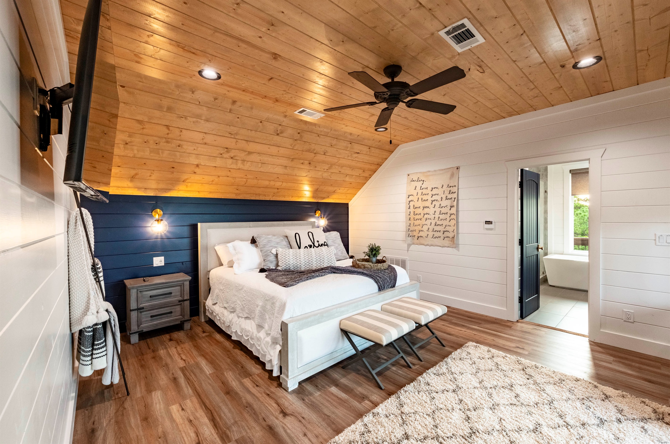 Cozy king bedroom with warm wood ceilings and peaceful cabin ambiance