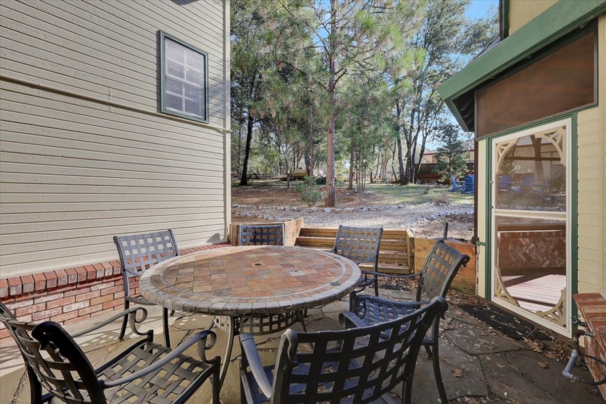 Small patio with outdoor dining, screened porch access, and a tucked-away spot for fresh air.

