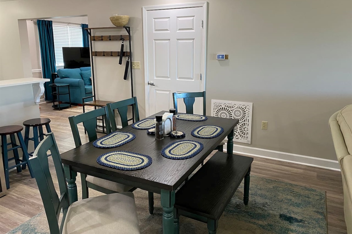 Dining table for six just in front of the kitchen bar top. 