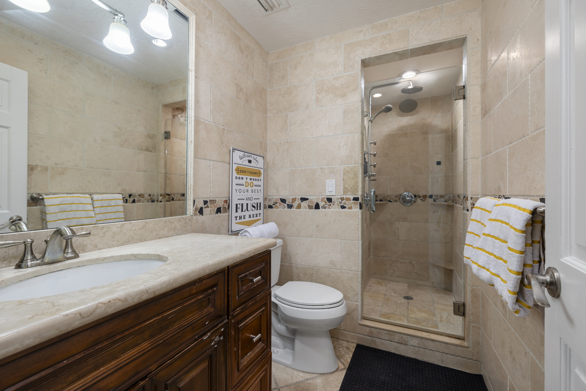 The first of four high end bathrooms, this one featuring two rain showers and spa jets.