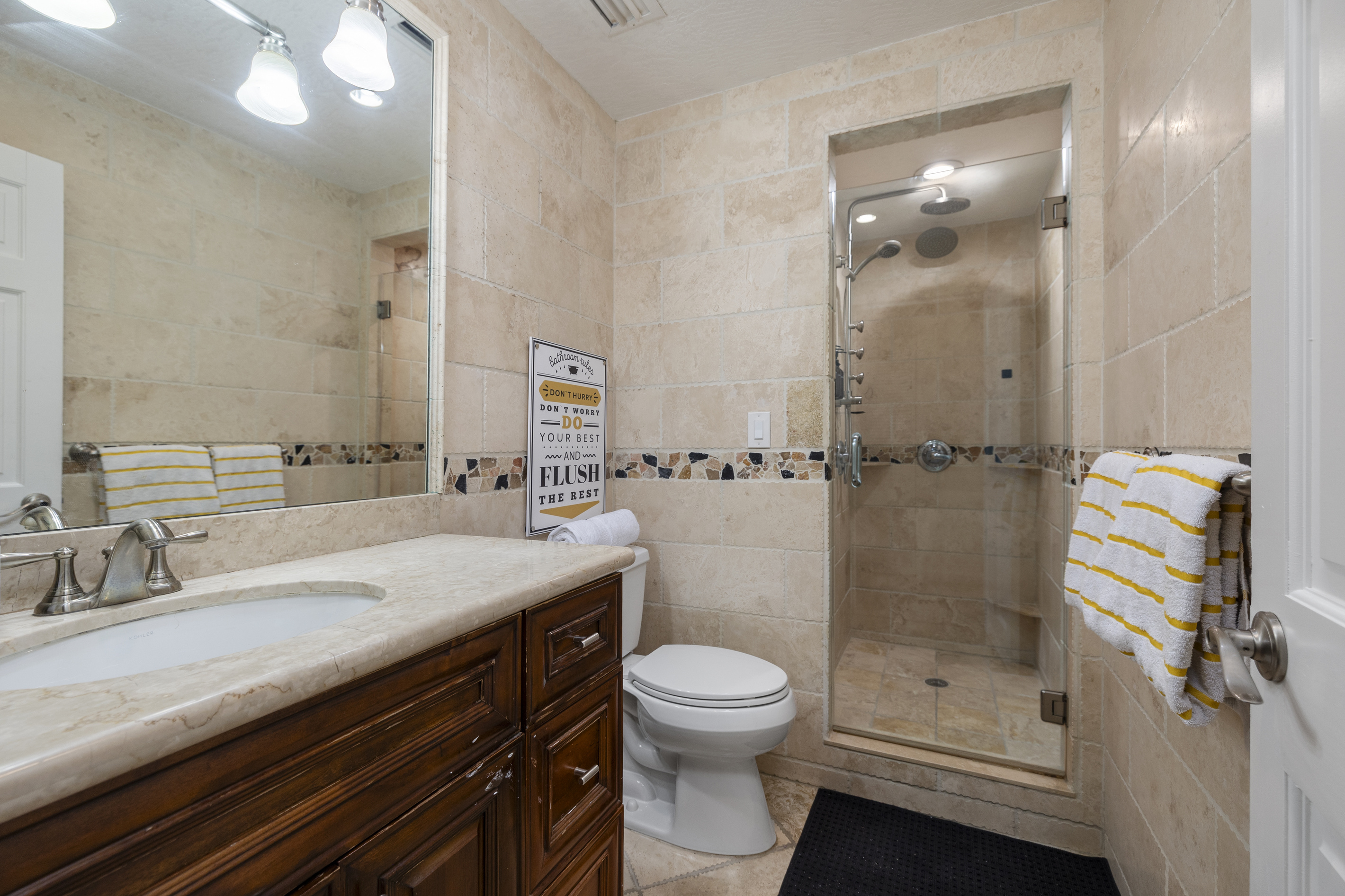 The first of four high end bathrooms, this one featuring two rain showers and spa jets.