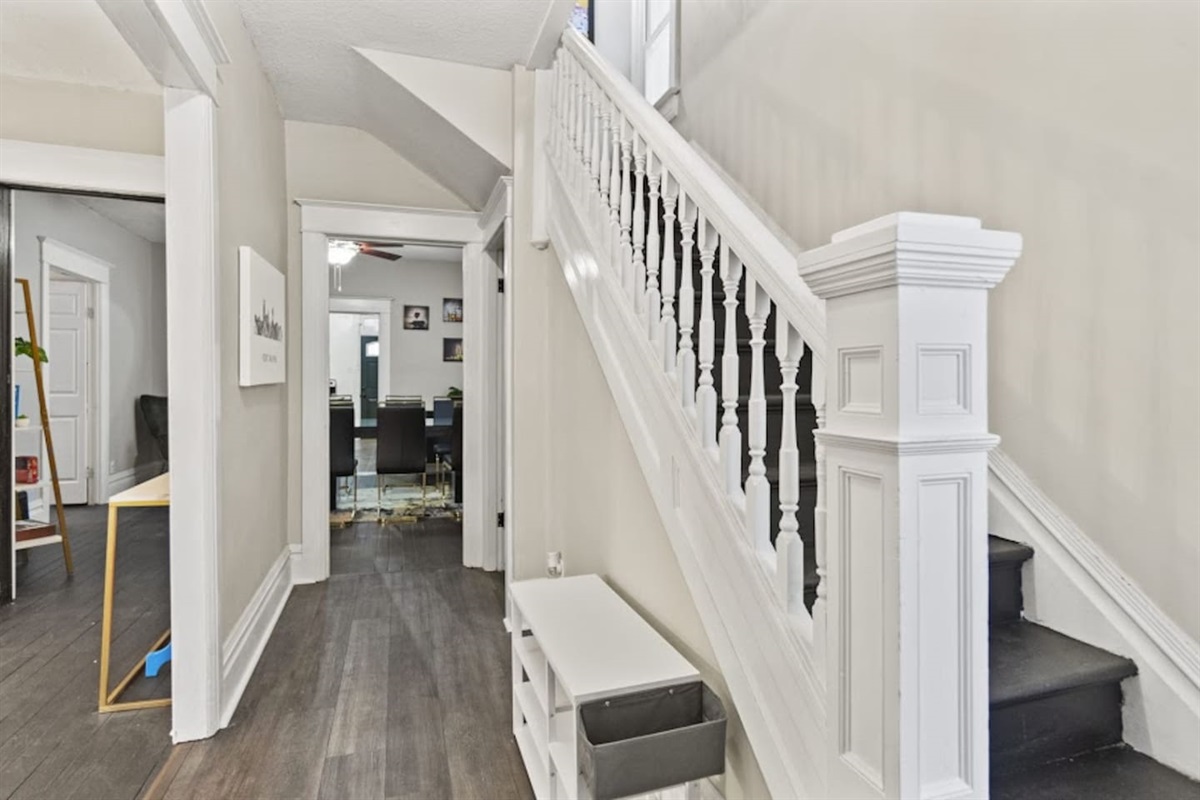 Stylish hallway with stairs leading to the 2nd floor, featuring cozy design elements, sleek flooring, and a warm, inviting ambiance—perfectly blending functionality with modern elegance