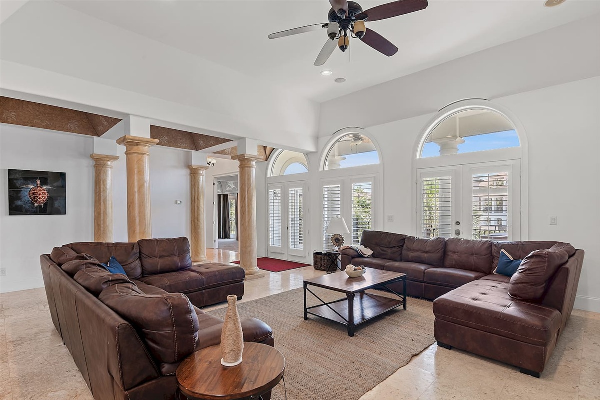 Spacious living area with high ceilings and abundant natural light