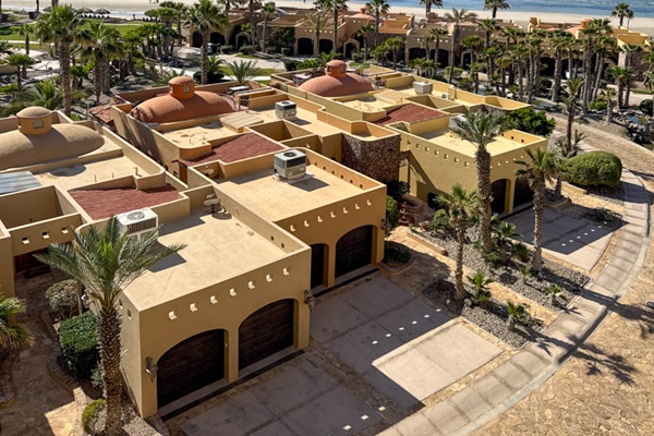 Patio overlooking Bella Sirena pools, lush grounds, and Sea of Cortez.