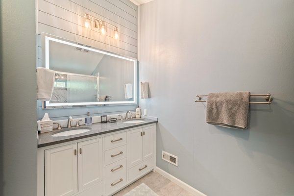 Bathroom #1 of 2: upstairs primary en suite with double vanity and LED mirror