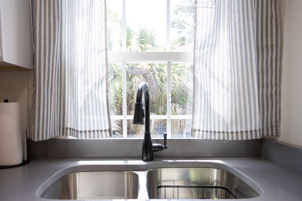 A sunny window over the sink brings in natural light and a touch of charm to your daily routine.