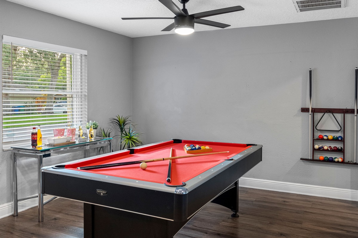 Whether you're sinking shots on the red felt pool table or battling it out in ping pong, this game room is built for endless entertainment.