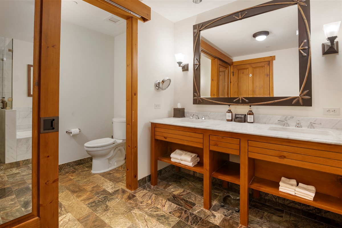 Double stone vanity, and separate water closet with sliding barn type door for privacy