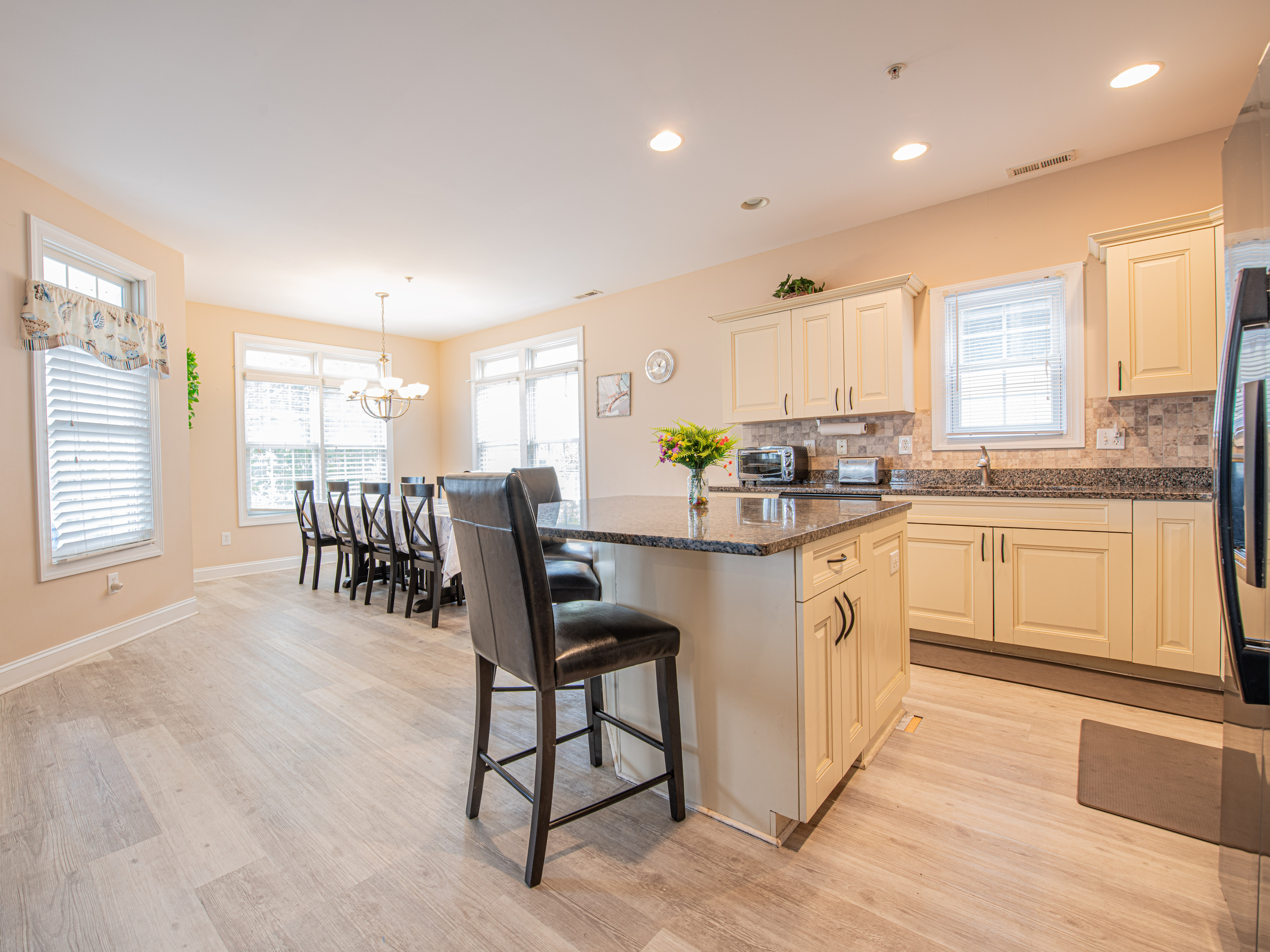 Open-Concept Kitchen and Dining Area with Center Island Bar Seating