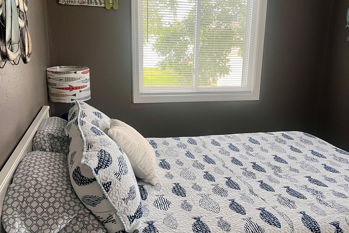 Queen bed showing view of the lake