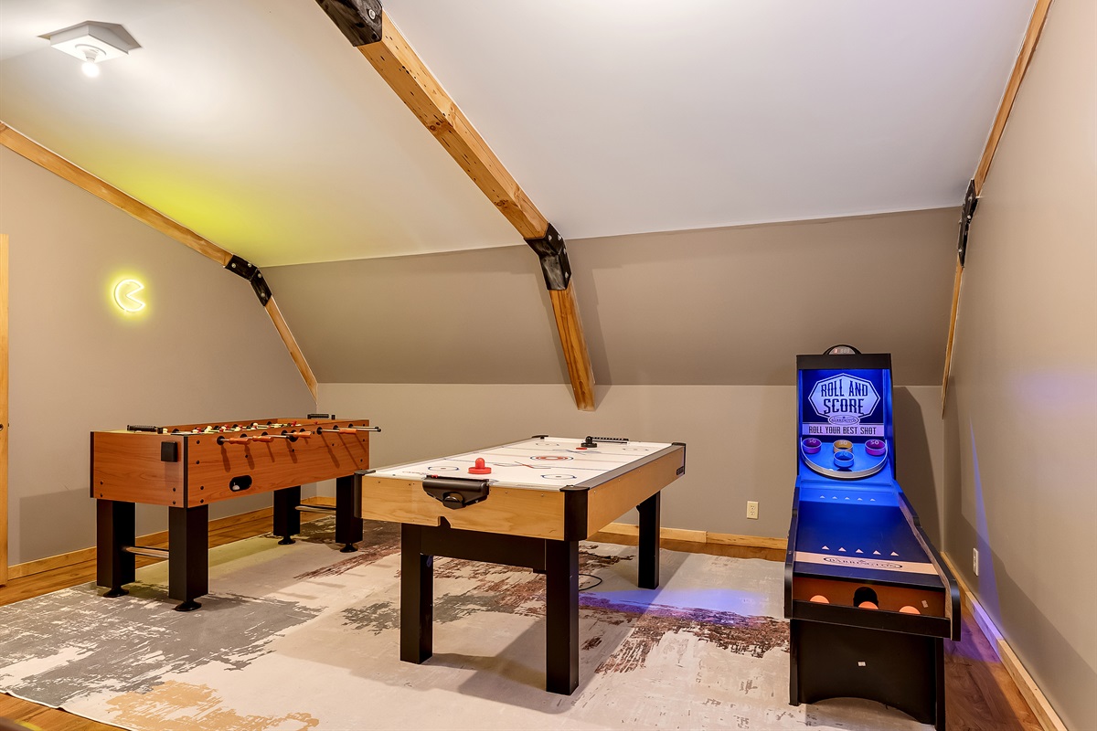Game room with Skee-Ball, Foosball, Air hockey, Pac-Man arcade game & Final Fight arcade game.