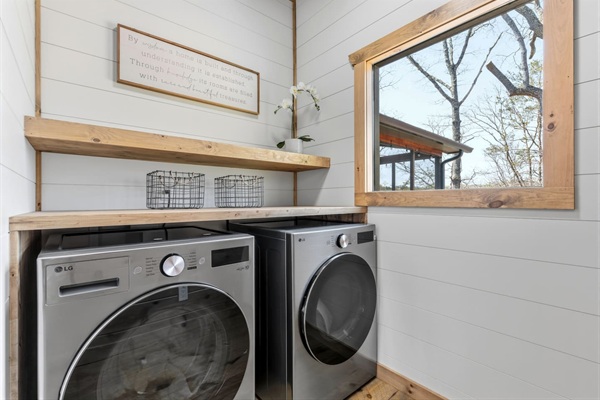 These x-large capacity washer/dryer and folding table make laundry a breeze. There is a large hanging rack on the opposite wall for delicates.
