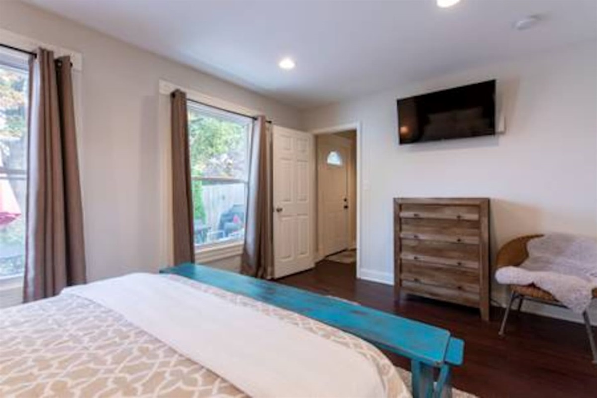 Master bedroom with dresser and TV