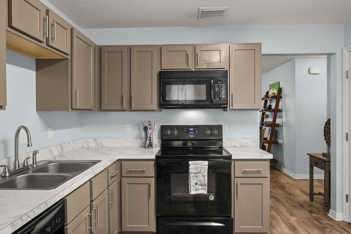 Unit #1 Left: Kitchen range and microwave.